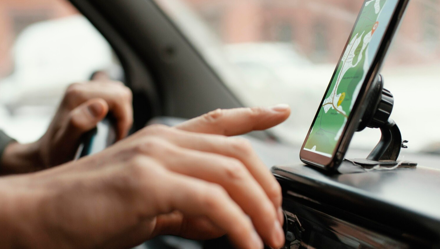 Close up man in the car with map on mobile